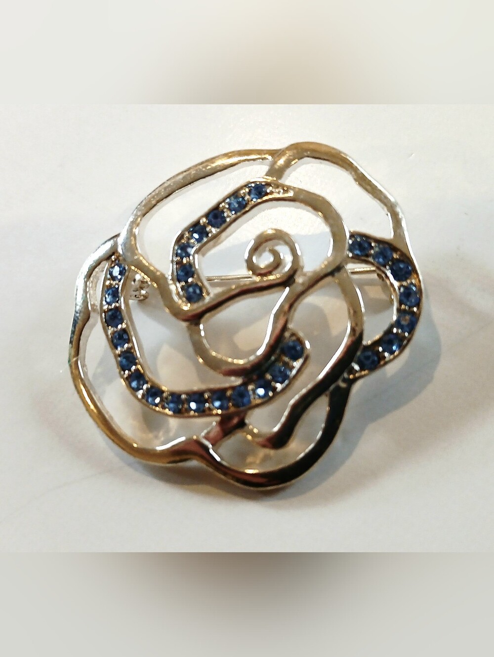 Elegant Floral Silvertone Brooch with Blue Crystal Accents - Picture 2 of 4